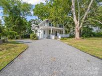 Charming two-story home with a gravel driveway and a welcoming front porch at 616 W Marion St, Shelby, NC 28150