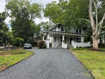 Charming two-story home with a black gravel driveway and inviting front porch at 616 W Marion St, Shelby, NC 28150