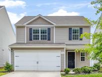 Charming two-story home with a two car garage, landscaped yard, and neutral siding at 9136 Creedmore Hills Dr, Charlotte, NC 28214