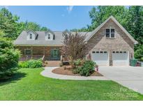 Charming brick home with a well-manicured lawn and an inviting covered porch at 260 River Country Rd, Salisbury, NC 28146