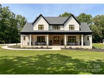 Stunning two-story home with a welcoming front porch and well-manicured lawn at 4023 Yesteryears Ln, Marshville, NC 28103