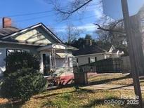Modest bungalow-style home with mature landscaping and inviting front porch at 410 Arthur Ave, Gastonia, NC 28052