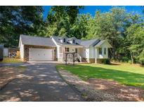 Charming home featuring a stone-accented garage and a well-manicured lawn at 4567 Hickory Grove Rd, Sharon, SC 29742