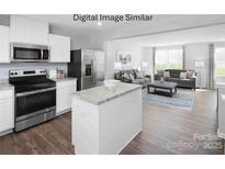 Open concept kitchen with stainless steel appliances flows into living area with lots of natural light at 5213 Crimson Kate Ln # 2007B, Charlotte, NC 28208