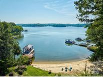 Beautiful lake view with a private sandy beach, dock, and covered boat slip at 5390 Hudson Rd, Clover, SC 29710