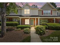 Charming townhome with brick facade, manicured landscaping, and inviting front porch at 5724 Cougar Ln, Charlotte, NC 28269