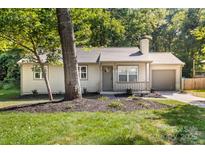 Charming single-story home featuring a cozy front porch, landscaped yard and a one car garage at 6515 Santa Cruz Trl, Charlotte, NC 28227