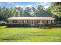 Charming brick home with a well-maintained lawn and manicured hedges in a serene setting at 753 Briarfield Rd, Rock Hill, SC 29730