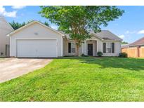 Charming single-Gathering home with a well-manicured lawn and attached two-car garage at 8724 Tweedsmuir Glen Ln, Charlotte, NC 28215