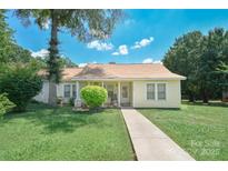 Charming one story home with a well-maintained front yard and inviting entrance at 1023 Parker St, Monroe, NC 28112