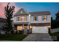 Charming two-story home with stone accents, blue shutters, and a well-manicured front lawn at 116 Kingsway Dr, Mooresville, NC 28115