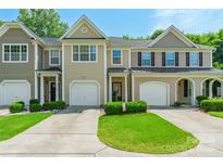 Charming townhome featuring a one-car garage and well-manicured front yard at 14755 Lions Paw St, Charlotte, NC 28273