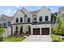 Beautiful two-story home with white siding, dark trim, covered porch, and attached two car garage at 18027 Wilbanks Dr, Charlotte, NC 28278