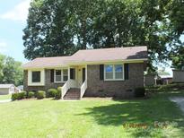 Charming brick home with a well-manicured lawn and inviting front porch at 2116 Upson Dr, Lancaster, SC 29720