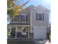 Charming two-story home featuring a covered porch and a two-car garage at 2440 Mint Thistle Ct, Charlotte, NC 28269