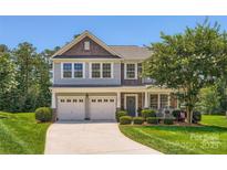 Charming two-story home with a well-manicured lawn, a two-car garage, and a welcoming front porch at 2630 Filson Ct, Charlotte, NC 28214