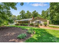 Inviting single story home featuring a well-manicured lawn and lush landscaping at 267 Winthrow Creek Rd, Mooresville, NC 28115