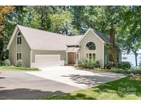 Inviting home with a two-car garage, beautiful landscaping, and a spacious driveway perfect for outdoor living at 2704 Apache Trl, Denver, NC 28037