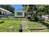 Charming home with a well-manicured front yard, fence, and inviting walkway at 300 Gurley St, Kannapolis, NC 28081