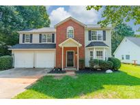 Charming two-story home with attached two car garage and manicured lawn at 4230 Chatterleigh Dr, Monroe, NC 28110