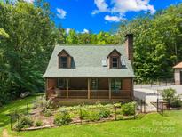 Charming home featuring a cozy front porch, well-maintained lawn, and private garden area at 485 Johnson St, China Grove, NC 28023