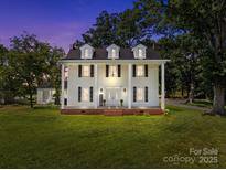 Beautiful two story traditional home with white siding, black shutters, and an inviting front porch at 550 Woodleaf Barber Rd, Cleveland, NC 27013