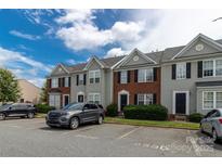 Well-maintained townhome exterior featuring classic architecture and convenient parking at 9530 Drains Bay Ct, Charlotte, NC 28214