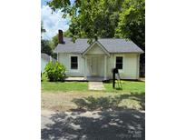 Charming single-story home with a cozy front porch and well-kept lawn and mature landscaping at 1008 Packard Ave, Kannapolis, NC 28083