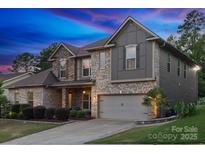 Beautiful two-story home featuring mixed material facade and attached two car garage at 1026 Arges River Dr, Fort Mill, SC 29715
