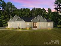 Charming single-story home featuring a landscaped yard, craftsman style architecture, and inviting front entrance at 108 Woodwinds St, Locust, NC 28097