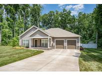 Charming single-story home with a three-car garage, manicured lawn, and inviting curb appeal at 1189 Quiet Acres Rd, Rock Hill, SC 29732