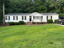 Charming single-story home with well-maintained lawn and inviting front porch at 1341 Pleasant Hill Church Rd, Wadesboro, NC 28170