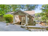 Inviting stone and siding facade with stylish entrance and stone walkway to the lake at 208 Island View Rd, Mount Holly, NC 28120