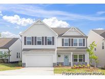 Charming two-story home with white siding, a two-car garage, and a welcoming front door at 233 Wheatfield Dr # 102P, Statesville, NC 28677