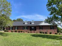 Charming single-story brick home with a well-manicured lawn and beautiful landscaping at 2515 Myra Ln, Lincolnton, NC 28092