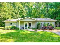 Charming single-story home featuring a well-manicured lawn, inviting front porch, and lush landscaping at 2984 Starnes Dr, Rock Hill, SC 29730
