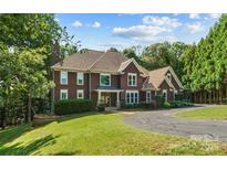 Stately two-story home boasts a well-manicured lawn, mature trees, and a welcoming driveway at 3916 2Nd Street Nw Dr, Hickory, NC 28601