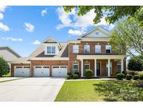 Stunning two-story brick home with a three car garage, beautifully landscaped yard and inviting front porch at 646 Quicksilver Trl # 183, Fort Mill, SC 29708