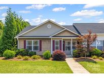 Charming single-story home with well-manicured landscaping and a welcoming front porch at 703 Dalebrook Ln, Rock Hill, SC 29730