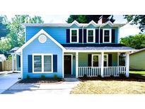 Charming two-story home featuring a welcoming front porch and a freshly painted exterior with contrasting shutters at 7219 Spring Morning Ln, Charlotte, NC 28227