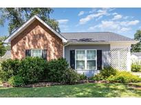 Charming single-story home with brick and siding, lush landscaping, and a well-manicured lawn at 1114 Cason St # 6, Belmont, NC 28012