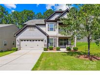 Charming two-story home with a two car garage, a front porch, and a well-manicured lawn at 120 Carolinian Dr, Statesville, NC 28677