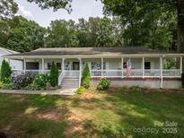 Charming home featuring a full-length front porch, lovely landscaping, and classic American style at 170 Eagle Dr, Salisbury, NC 28144