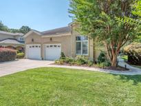 Stunning home with a lush green lawn, a charming tree, and a two-car garage, exudes curb appeal at 17709 Sedona Way, Cornelius, NC 28031