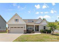 Charming single-Gathering home with a two-car garage, a manicured lawn, and stone and siding accents at 18568 Mainsail Ct, Lancaster, SC 29720