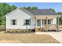 Charming single-Gathering home features white siding, green shutters, a cozy porch, and a well-manicured front yard at 286 Old Pinckney Rd, York, SC 29745