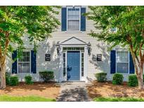 Charming entryway with a blue door, flanked by windows with blue shutters, and neat landscaping at 3849 Carl Parmer Dr, Harrisburg, NC 28075
