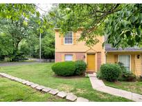 Charming two-story home with yellow siding, a brick foundation, and a well-manicured lawn at 3919 Briarhill Dr, Charlotte, NC 28215