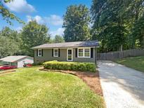 Charming single-story home featuring a well-maintained lawn, garden bed, and concrete driveway at 4903 Jamee Dr, Gastonia, NC 28056