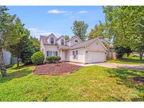 Charming home featuring dormer windows, well-maintained landscaping, and an attached two-car garage at 5417 Timbertop Ln, Charlotte, NC 28215